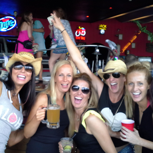 A group of young women partying at a local Lake of the Ozarks bar, just one exciting stops on Playin Hooky's Aqua Shuttle cruise.