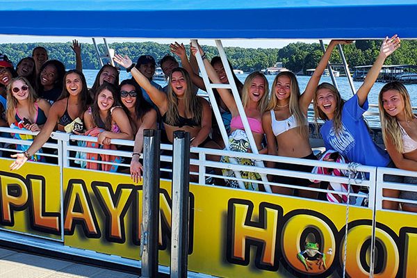 A group of adults aboard one of Playin Hooky's boats for a day time bar hop.